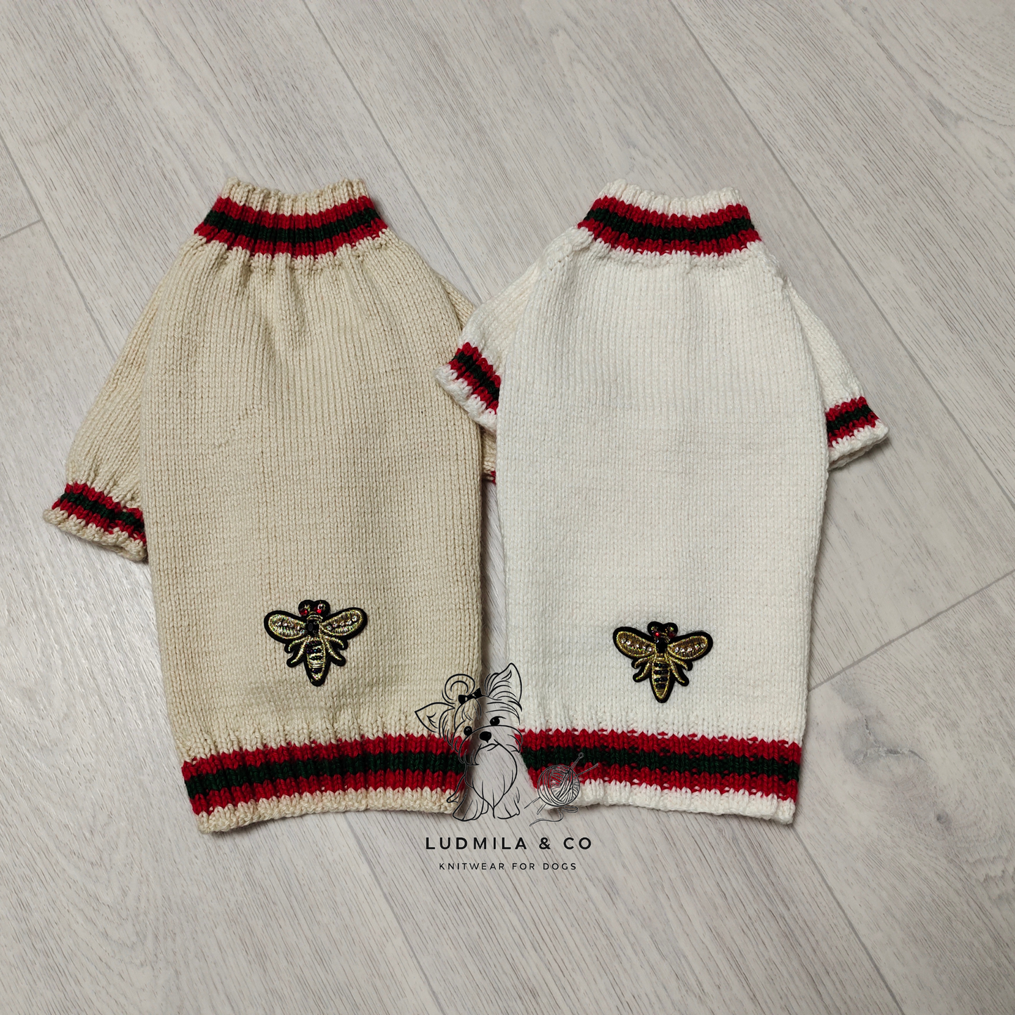 Yorkie wearing black knitted dog sweater with red and green stripes and gold bee embroidery – knitting pattern PDF