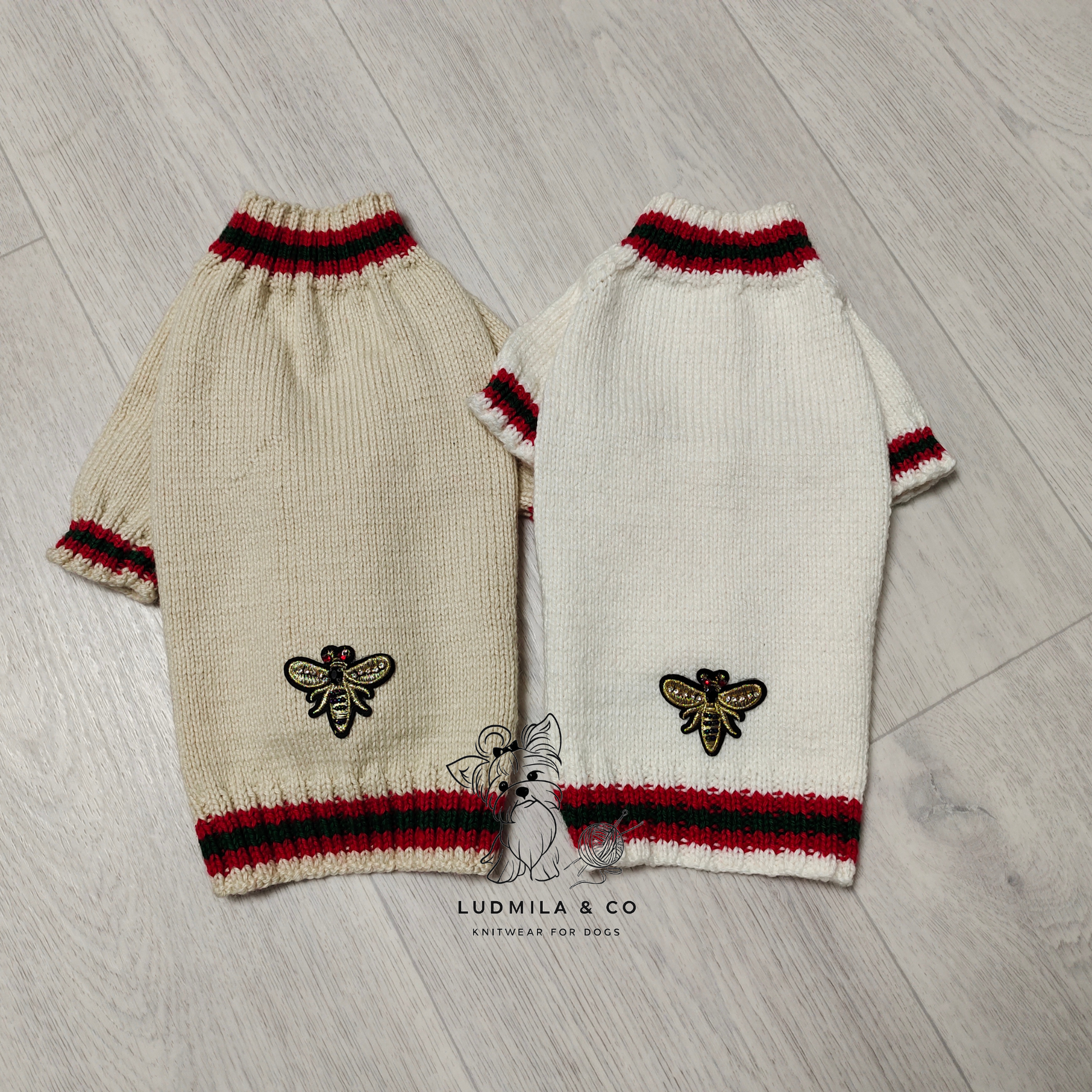 Yorkie wearing black knitted dog sweater with red and green stripes and gold bee embroidery – knitting pattern PDF